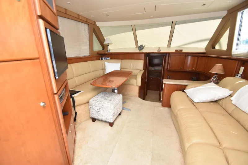 Slide: The Image of Luxurious interior of 2007 Silverton 38 Convertible yacht with beige leather seating and wooden accents. - 30