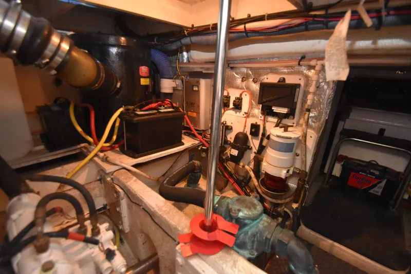 Slide: The Image of Engine room of a 2007 Silverton 38 Convertible boat, showcasing mechanical components and wiring. - 32