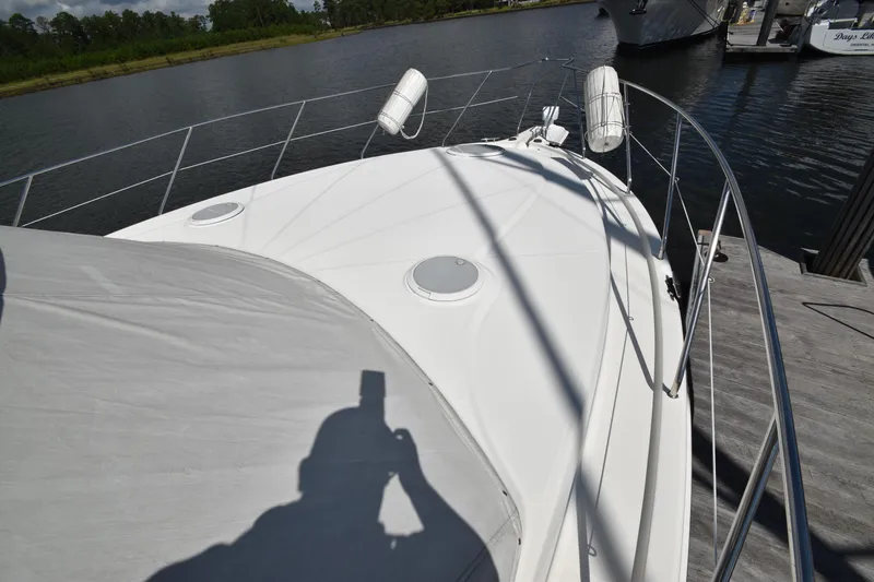 Slide: The Image of 2007 Silverton 38 Convertible yacht deck with railing and water view. - 6