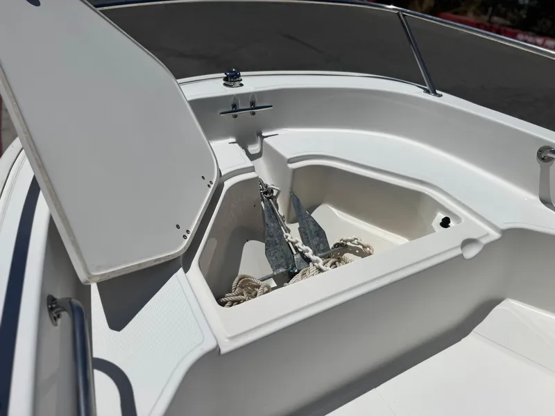 Slide: The Image of Open anchor compartment on a 2021 Boston Whaler 130 Super Sport boat. - 9