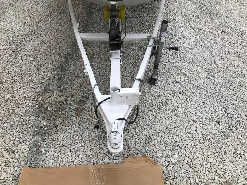 Slide: The Image of Trailer hitch of a 1995 Ranger Cherokee 17' boat on gravel surface. - 5