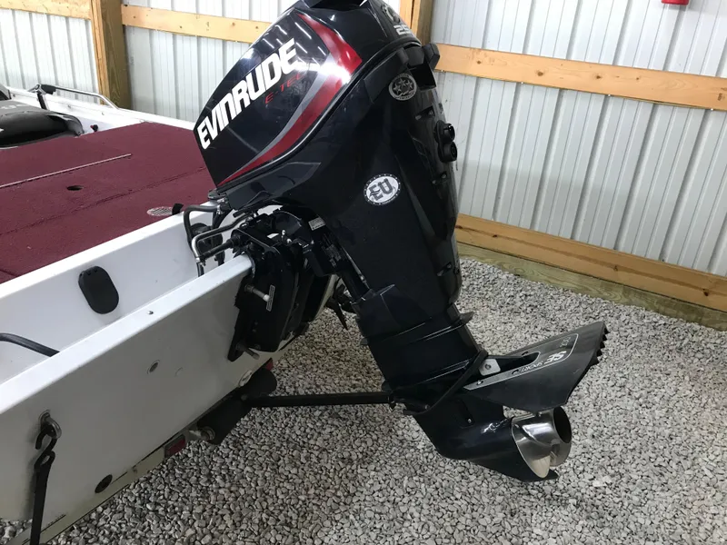 Slide: The Image of 1995 Ranger Cherokee 17' boat with Evinrude outboard motor in a garage setting. - 6
