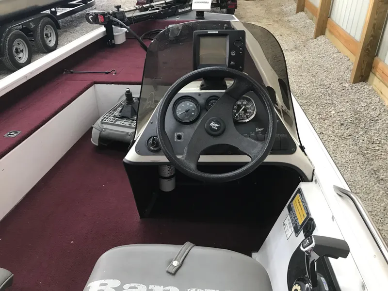 Slide: The Image of 1995 Ranger Cherokee 17' boat cockpit with steering wheel and control panel. - 7