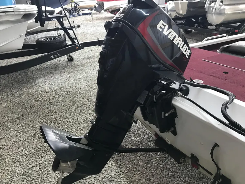 Slide: The Image of 1995 Ranger Cherokee 17' boat with Evinrude outboard motor on gravel surface. - 8