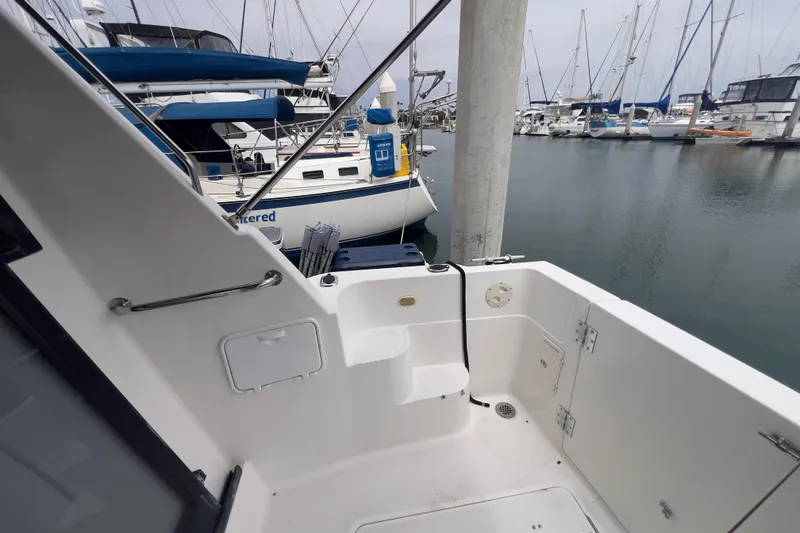 Slide: The Image of 1999 Bayliner 3988 Command Bridge Motoryacht docked at marina, featuring clean deck area. - 10