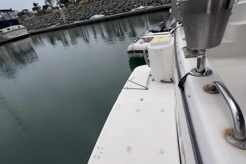 Slide: The Image of 1999 Bayliner 3988 Command Bridge Motoryacht docked in a calm marina. - 12