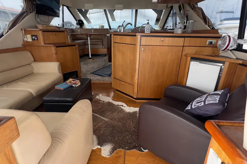 Slide: The Image of Interior of 1999 Bayliner 3988 Command Bridge Motoryacht with cozy seating and kitchenette. - 13