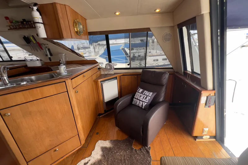Slide: The Image of Interior of 1999 Bayliner 3988 Command Bridge Motoryacht with cozy seating and kitchenette. - 15