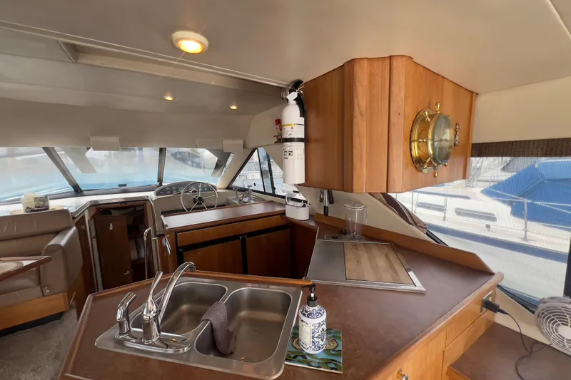 Slide: The Image of Interior of 1999 Bayliner 3988 Command Bridge Motoryacht with kitchen and helm. - 18