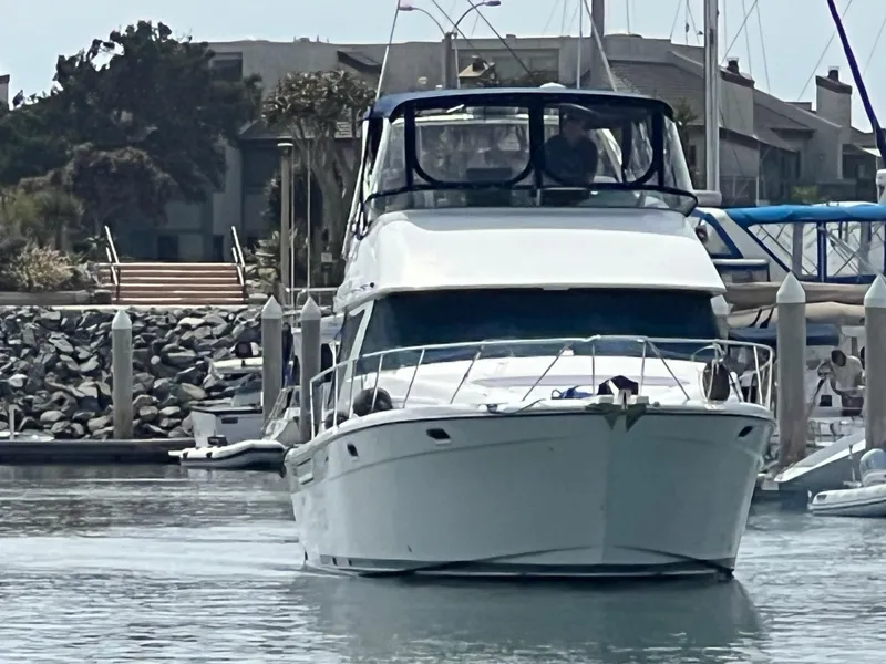 Slide: The Image of 1999 Bayliner 3988 Command Bridge Motoryacht docked in a marina. - 2