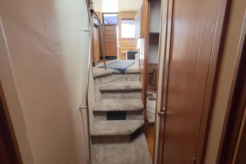 Slide: The Image of Interior of 1999 Bayliner 3988 Command Bridge Motoryacht with carpeted stairs and wooden cabinetry. - 34