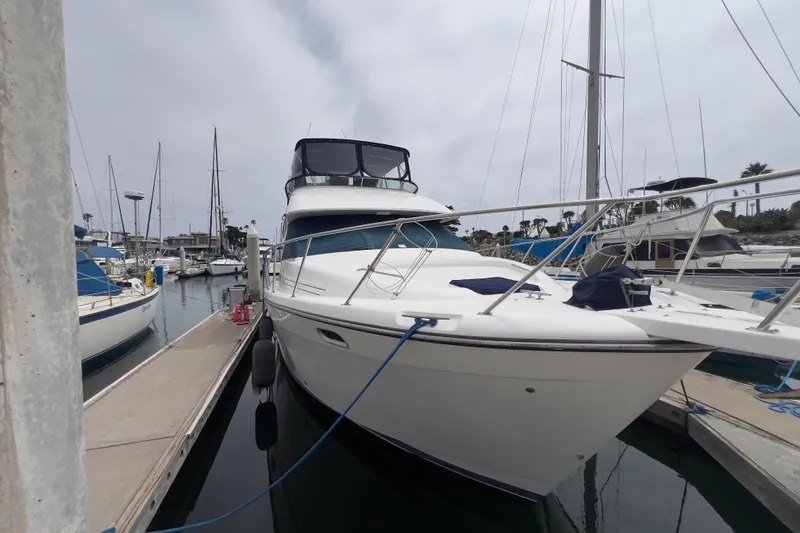 Slide: The Image of 1999 Bayliner 3988 Command Bridge Motoryacht docked at marina, side view. - 35