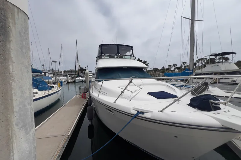 Slide: The Image of 1999 Bayliner 3988 Command Bridge Motoryacht docked at marina, surrounded by sailboats. - 36