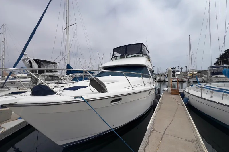 Slide: The Image of 1999 Bayliner 3988 Command Bridge Motoryacht docked at marina, surrounded by sailboats. - 37