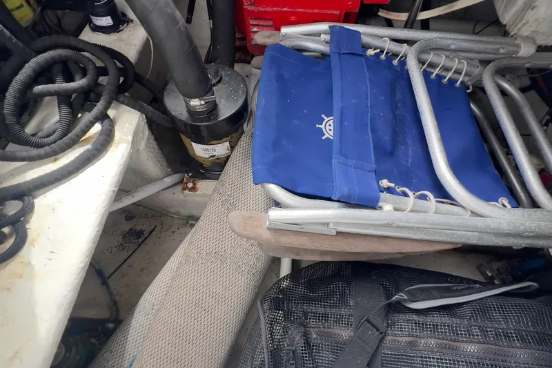 Slide: The Image of 1999 Bayliner 3988 Command Bridge Motoryacht interior with blue folding chair and equipment. - 40