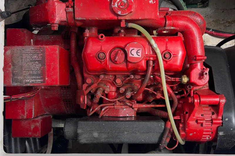 Slide: The Image of Red engine of a 1999 Bayliner 3988 Command Bridge Motoryacht, showcasing intricate components. - 41