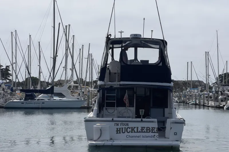 Slide: The Image of 1999 Bayliner 3988 Command Bridge Motoryacht docked in a marina with sailboats. - 42