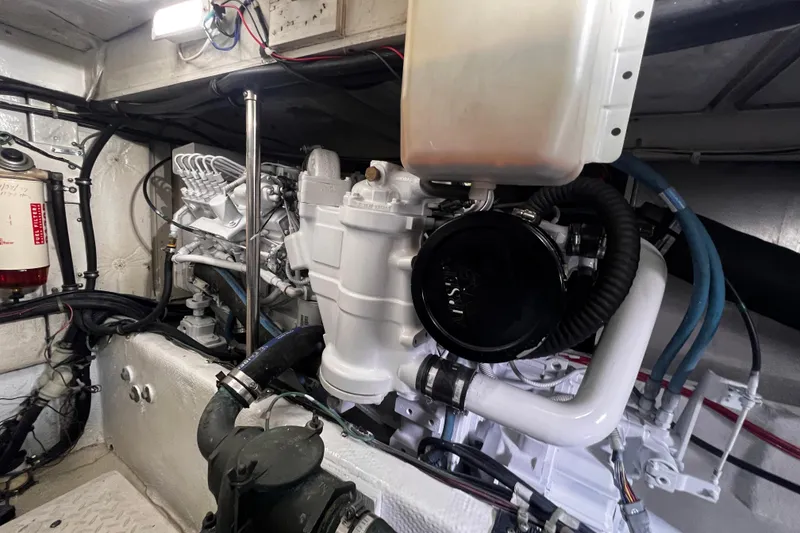 Slide: The Image of Engine room of 1999 Bayliner 3988 Command Bridge Motoryacht, showcasing mechanical components. - 47