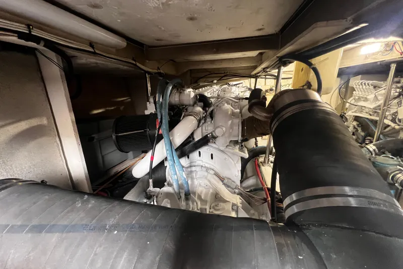 Slide: The Image of Engine room of 1999 Bayliner 3988 Command Bridge Motoryacht, showcasing mechanical components. - 49