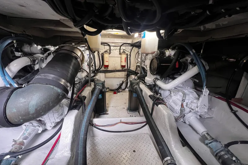 Slide: The Image of Engine room of a 1999 Bayliner 3988 Command Bridge Motoryacht, showcasing mechanical components. - 51