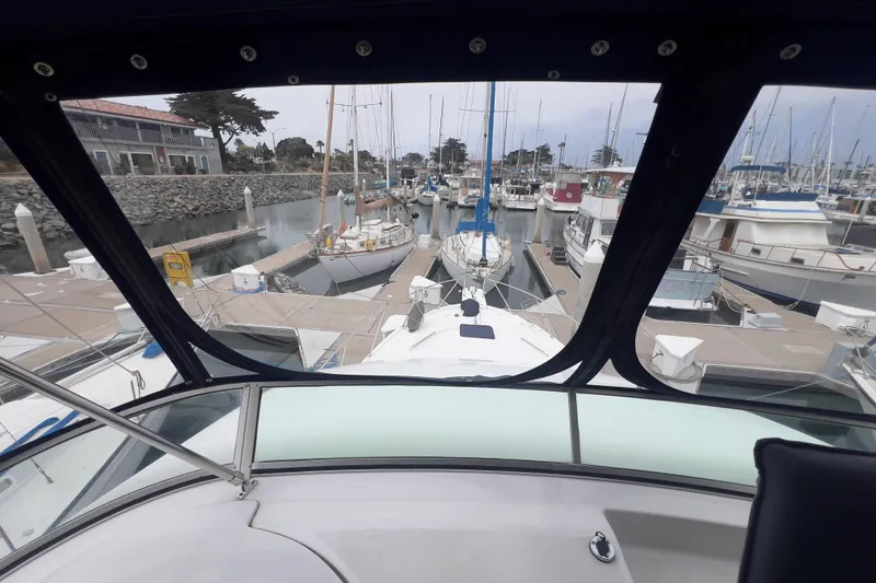 Slide: The Image of 1999 Bayliner 3988 Command Bridge Motoryacht docked in a marina, view from the helm. - 6