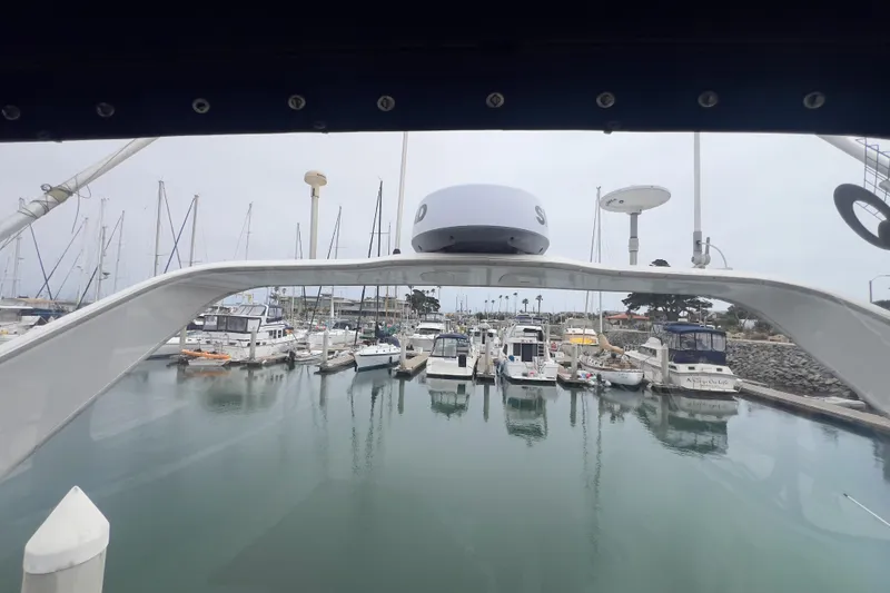 Slide: The Image of 1999 Bayliner 3988 Command Bridge Motoryacht docked in a marina with other boats. - 7