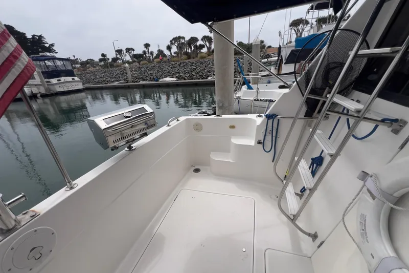 Slide: The Image of 1999 Bayliner 3988 Command Bridge Motoryacht docked, featuring outdoor seating and grill. - 9