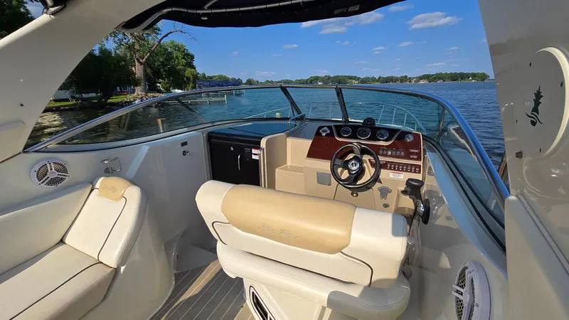 Slide: The Image of 2009 Sea Ray 270 Sundancer boat interior with steering wheel, seats, and lake view. - 6