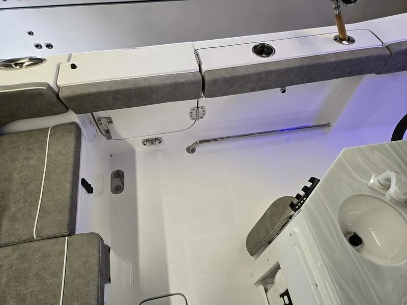 Slide: The Image of 2026 Sea Hunt Ultra 275 SE boat interior with seating and sink. - 10