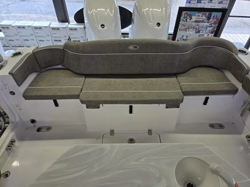 Slide: The Image of 2026 Sea Hunt Ultra 275 SE boat interior with cushioned seating and modern design. - 11