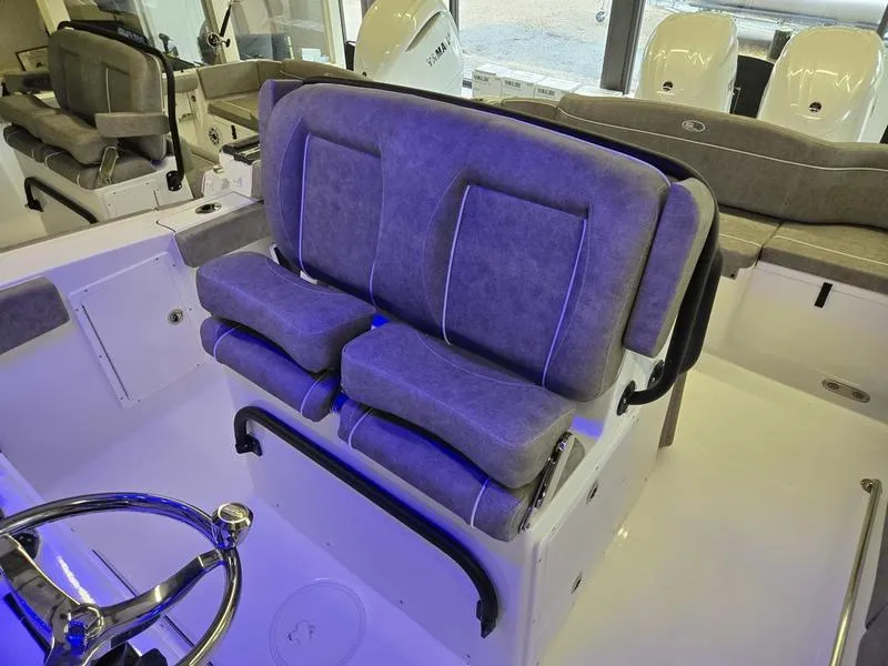 Slide: The Image of 2026 Sea Hunt Ultra 275 SE boat interior with plush seating and modern steering wheel. - 16