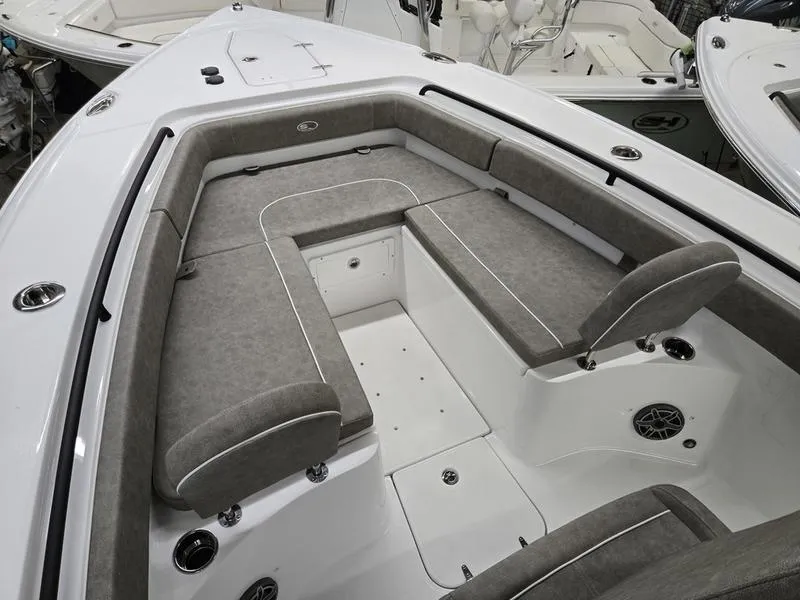 Slide: The Image of 2026 Sea Hunt Ultra 275 SE boat interior with cushioned seating and storage compartments. - 7