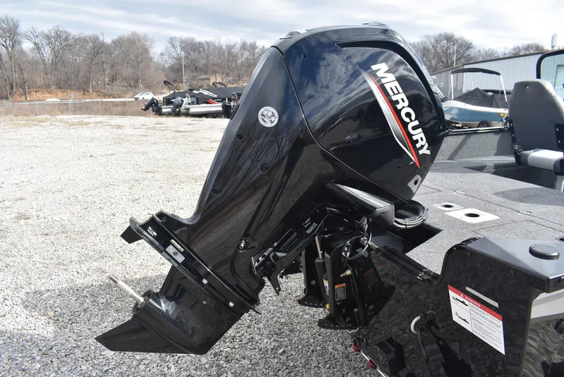 Slide: The Image of 2025 Lowe FM 1675 WT boat with Mercury outboard motor in a gravel lot. - 12