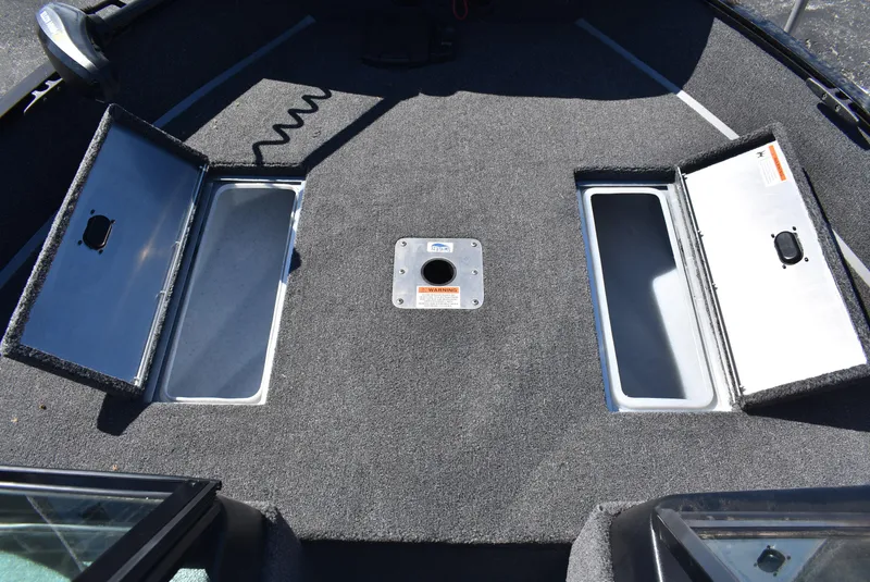 Slide: The Image of 2025 Lowe FM 1675 WT boat interior with open storage compartments. - 14