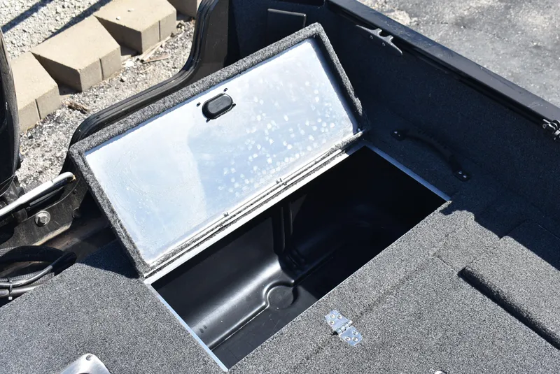 Slide: The Image of Open storage compartment in a 2025 Lowe FM 1675 WT boat. - 18