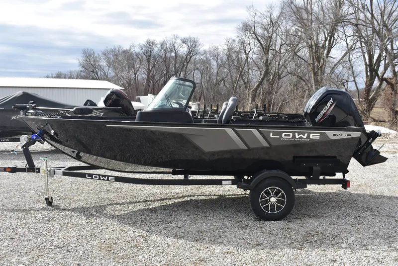 Slide: The Image of 2025 Lowe FM 1675 WT fishing boat on trailer, parked outdoors. - 4
