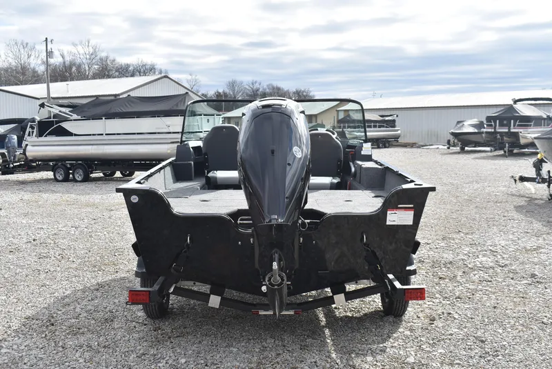 Slide: The Image of 2025 Lowe FM 1675 WT boat with outboard motor, parked on gravel lot. - 5