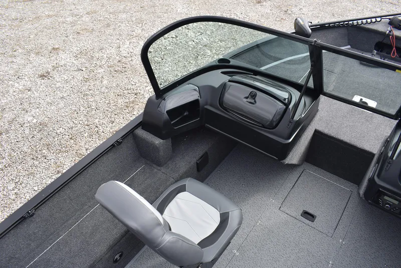 Slide: The Image of 2025 Lowe FM 1675 WT boat interior with seating and dashboard, featuring modern design elements. - 7