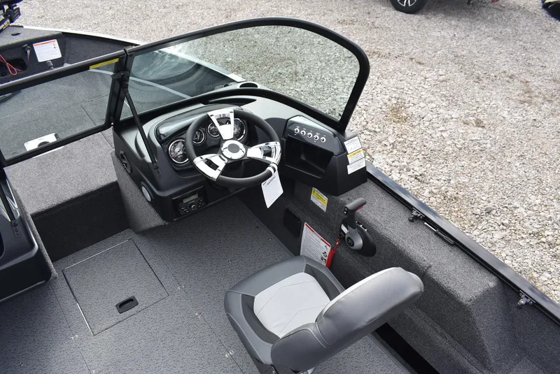 Slide: The Image of 2025 Lowe FM 1675 WT boat interior with steering wheel and seating. - 8