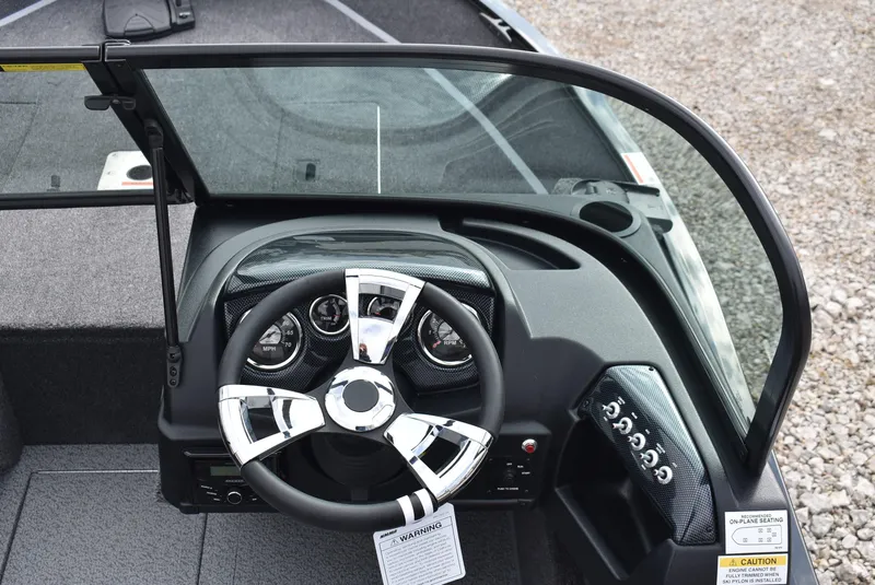 Slide: The Image of 2025 Lowe FM 1675 WT boat dashboard with steering wheel and control panel. - 9