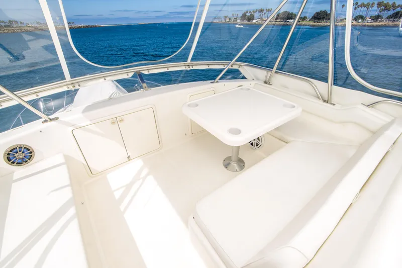 Slide: The Image of 1999 Riviera 43 Open Flybridge yacht interior with seating and table, overlooking ocean view. - 12