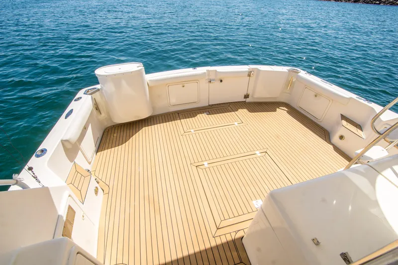 Slide: The Image of Spacious deck of 1999 Riviera 43 Open Flybridge yacht on calm water. - 13