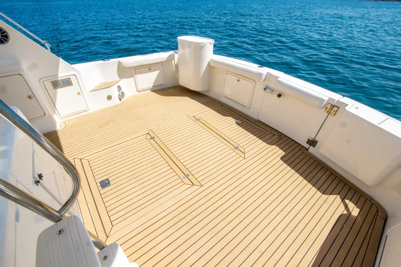Slide: The Image of Spacious deck of 1999 Riviera 43 Open Flybridge yacht with teak flooring, overlooking blue ocean. - 14