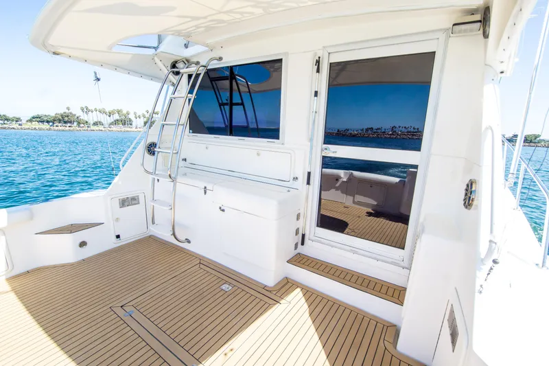 Slide: The Image of 1999 Riviera 43 Open Flybridge yacht deck with ocean view and sleek design. - 16