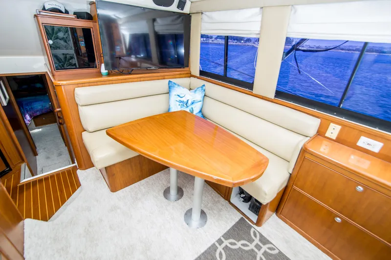 Slide: The Image of Interior of 1999 Riviera 43 Open Flybridge with dining area and ocean view. - 21