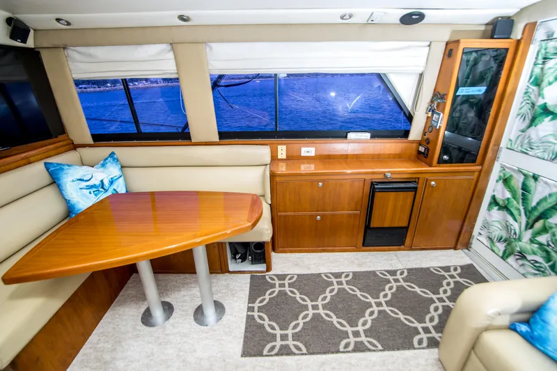 Slide: The Image of Interior of 1999 Riviera 43 Open Flybridge yacht with dining area and ocean view. - 22