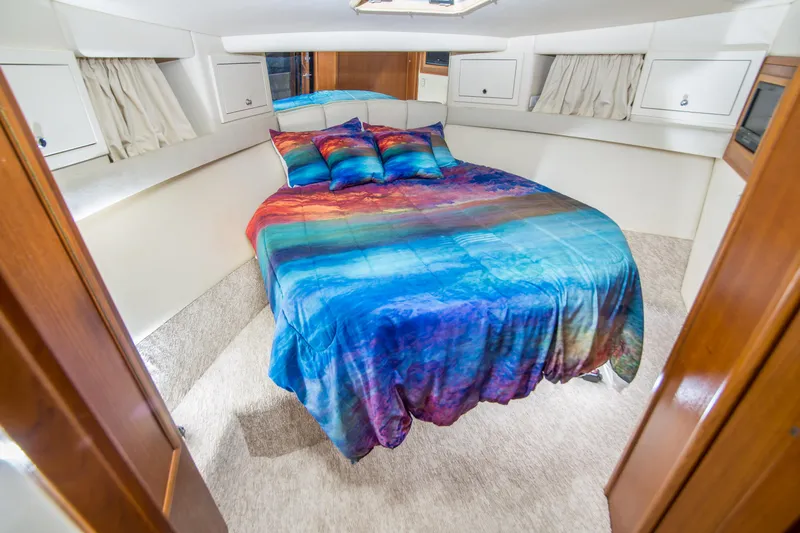 Slide: The Image of Luxurious bedroom in 1999 Riviera 43 Open Flybridge yacht with vibrant bedding. - 27