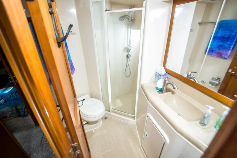 Slide: The Image of Bathroom interior of 1999 Riviera 43 Open Flybridge yacht with shower, sink, and toilet. - 29