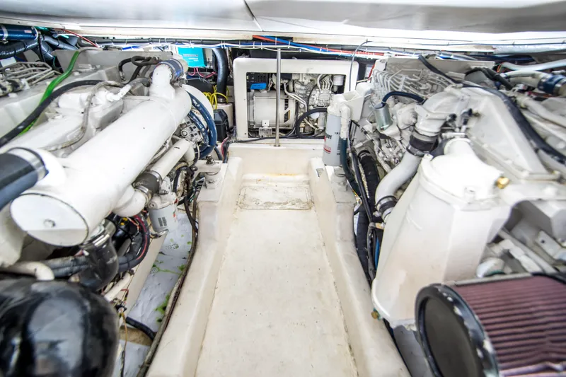 Slide: The Image of Engine room of 1999 Riviera 43 Open Flybridge with visible machinery and components. - 31