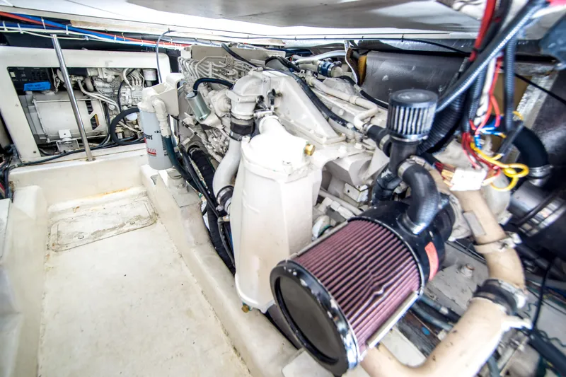 Slide: The Image of Engine room of 1999 Riviera 43 Open Flybridge, showcasing mechanical components and wiring. - 32